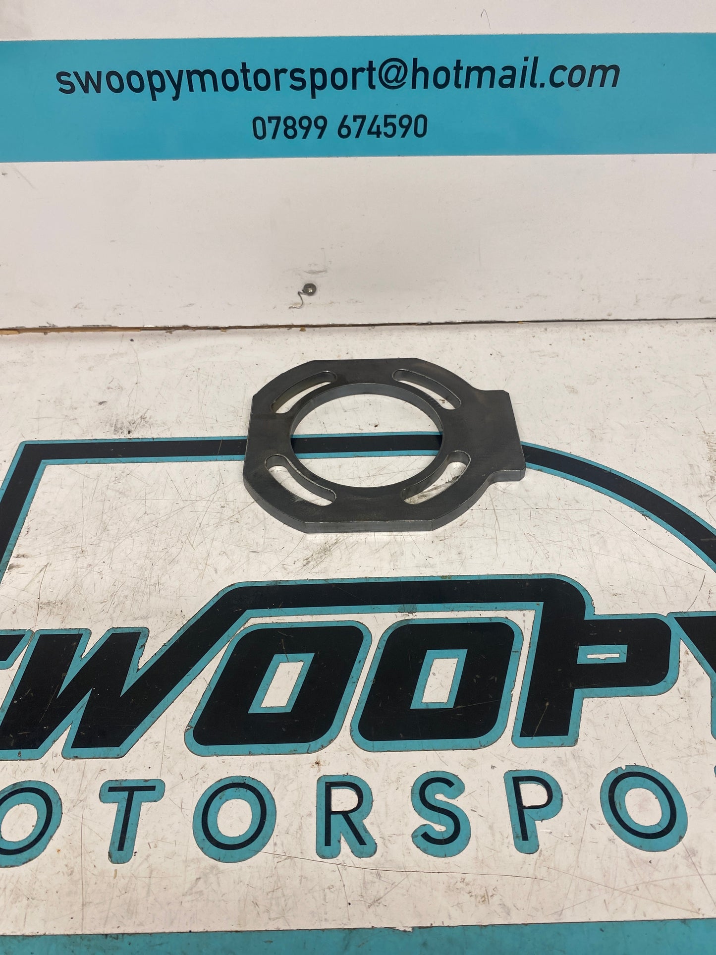 Swing arm bearing carrier plate SM0017